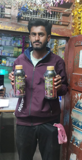 Product user holding Shakthi bottles